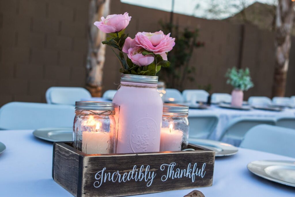 Pink flowers and candles in decorative box.